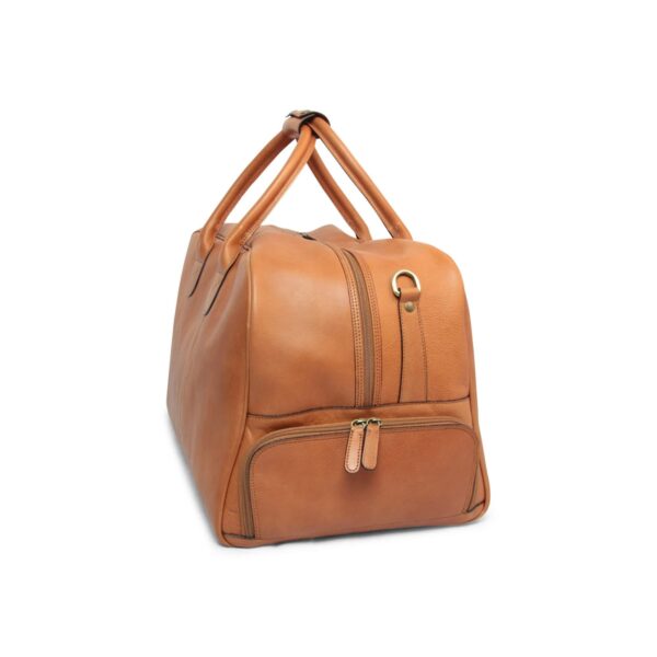 A side-angle view of a tan leather duffel bag on a white background, highlighting a separate zippered side compartment, a brass D-ring for strap attachment, and sturdy top handles joined by a leather wrap.