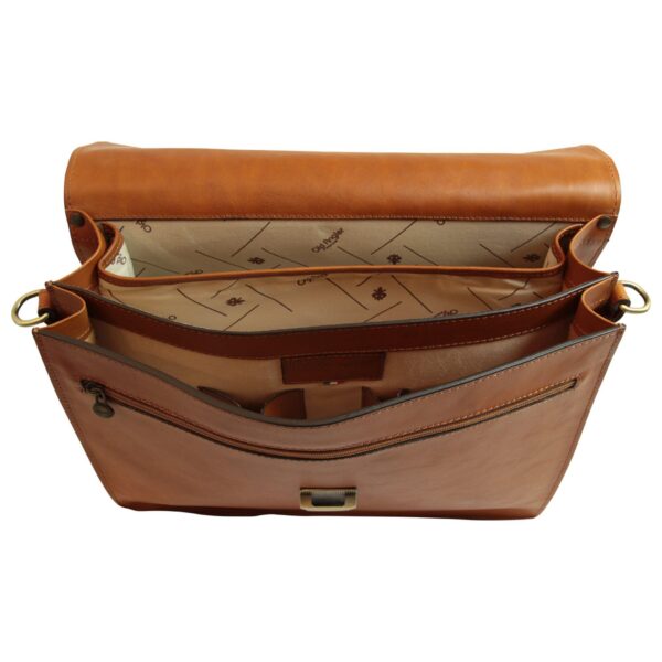 Top-down interior view of an open tan leather briefcase messenger bag, showing two main compartments lined with branded beige fabric. Features include an internal zippered pocket, pen holders, a small Italian flag detail on a leather patch, and brass hardware loops for a shoulder strap.