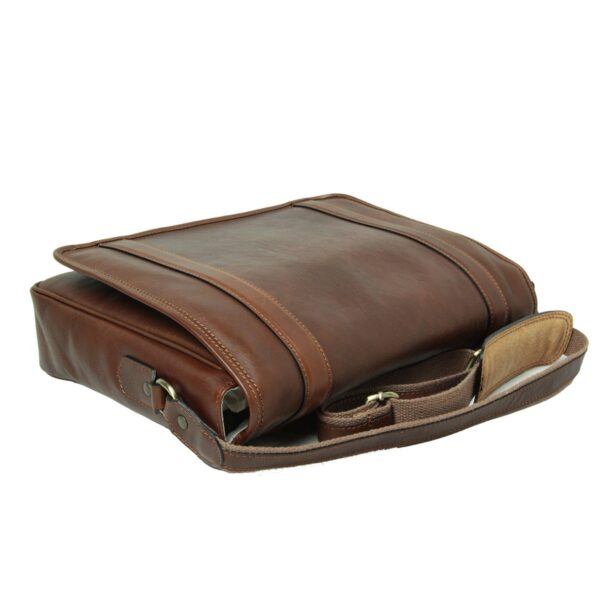 A brown leather messenger bag with a large front flap and two vertical leather straps, shown lying flat with its adjustable shoulder strap tucked underneath on a white background.