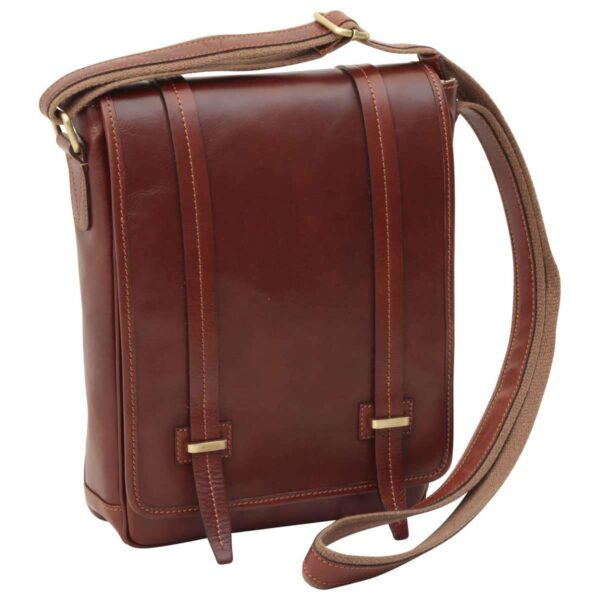A back-angled view of a tan leather messenger bag featuring a horizontal zippered pocket, brass hardware, and a matching adjustable canvas shoulder strap.
