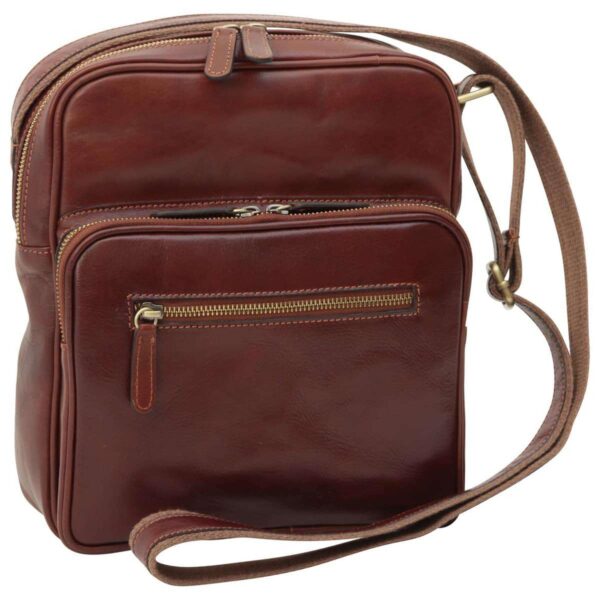 Front view of a rectangular, dark brown leather messenger bag featuring multiple zippered sections, including a large main compartment and a front pocket with an additional horizontal zip, all finished with brass-tone hardware and a matching leather shoulder strap.