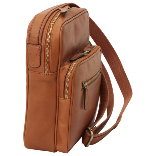 Side view of a tan leather messenger bag, highlighting multiple zippered compartments including a main section, a front organizer pocket, and a small horizontal zip pocket on the front.
