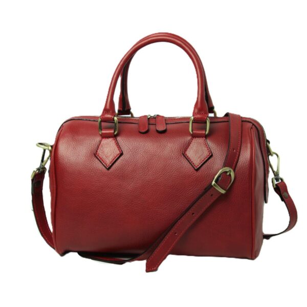 A vibrant red pebble-grain leather Boston bag featuring rolled top handles, an adjustable crossbody strap with a brass buckle, and gold-toned hardware. The bag includes a double-zippered top closure and signature diamond-shaped leather reinforcements at the handle bases, set against a plain white background.