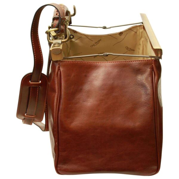 A side-view shot of an open vintage-style brown leather doctor's bag, showcasing the bag's depth and the collapsible metal frame mechanism. The interior features "Old Angler" branded lining, and a matching leather shoulder strap with a comfort pad is visible on the left side.
