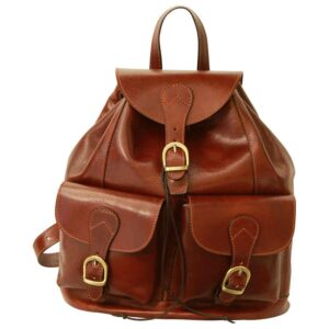 A full-view shot of a vintage-style brown leather backpack featuring a main compartment flap with a buckle closure, two front pockets also with buckle straps, a small top handle, and rich, polished leather with fine stitching throughout.