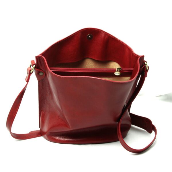 Red leather shoulder bag front view with adjustable strap, magnetic closure, and inner zip pocket on white background