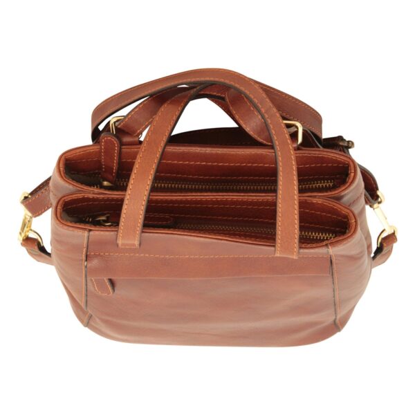 A top-down view of a different cognac-brown leather handbag, showing two main zippered compartments, sturdy leather handles, and gold-toned metal hardware against a white background.