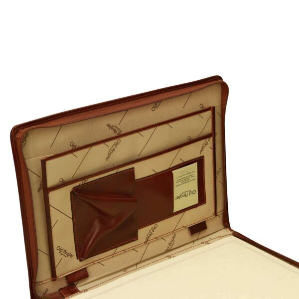 An interior view of an open leather portfolio, focusing on the organizational panel. The lining features a cream-colored fabric with a diagonal "Old Angler" logo pattern. It includes a large document sleeve, a leather business card holder with a visible card, and a gusseted pocket. Two leather pen loops are positioned at the bottom, all framed by a sturdy perimeter zipper.