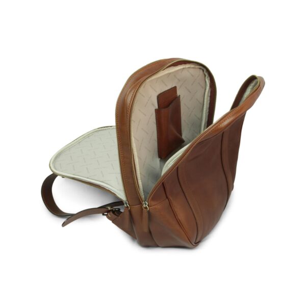 Interior view of an open tan brown leather backpack showing a spacious compartment with cream lining and a leather internal pocket