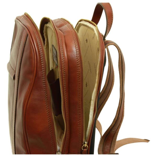 Side view of dark brown leather backpack showing its slim profile and adjustable shoulder straps